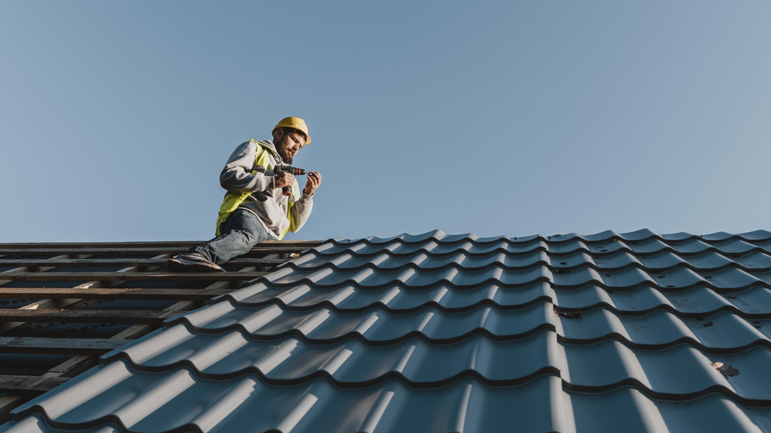 long shot man working roof scaled